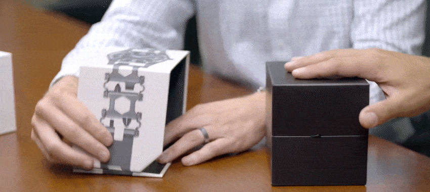 Two packaging experts showing an unboxing of Leatherman's luxury packaging and products