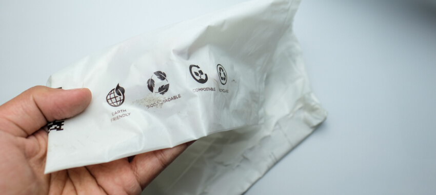 A hand holding a biodegradable bag made of bioplastic material