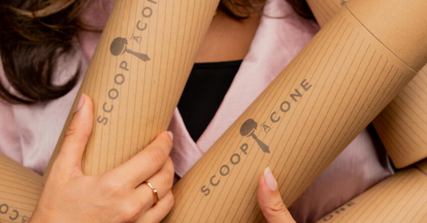 Hands holding cylindrical bamboo or cardboard tubes with 