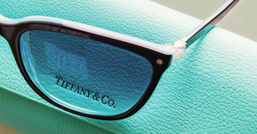 Tiffany & Co. designer eyeglasses resting on signature robin's egg blue leather packaging box