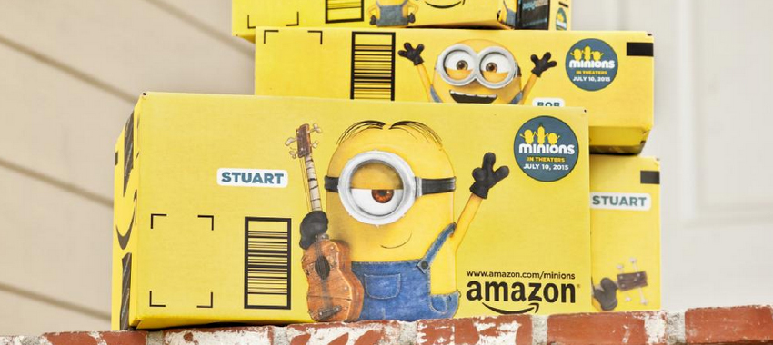 Amazon branded decorative boxes for Minions stacked on a brick porch.