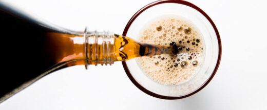 A glass of cola being poured into a glass