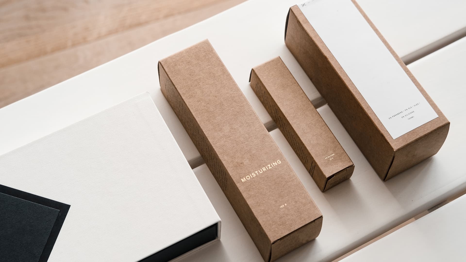 Cosmetic boxes arranged by size on a counter.